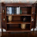 F06. Bookshelf with inlaid band on top. 35&rdquo;h x 43&rdquo;w x 11&rdquo;d 